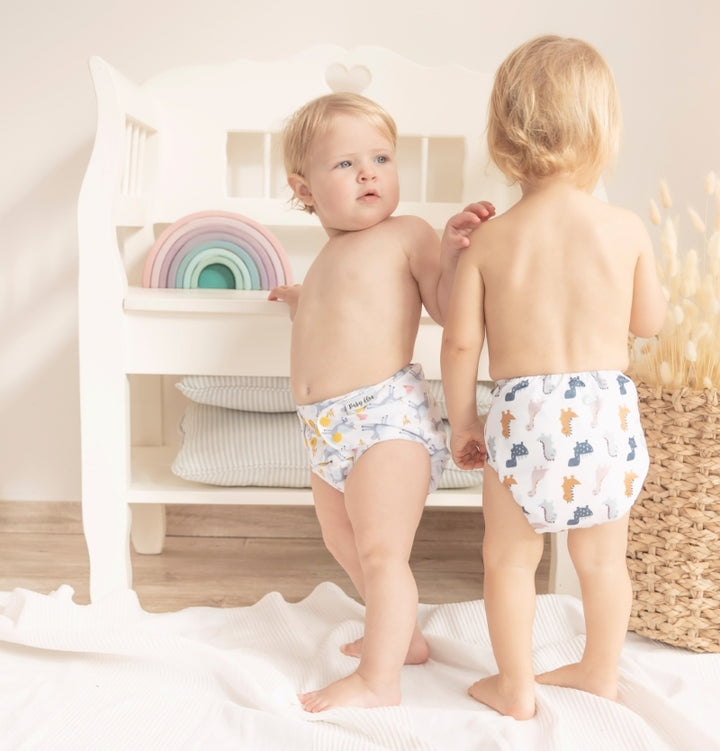 a girl and a boy are playing in baby elsa cloth diaper